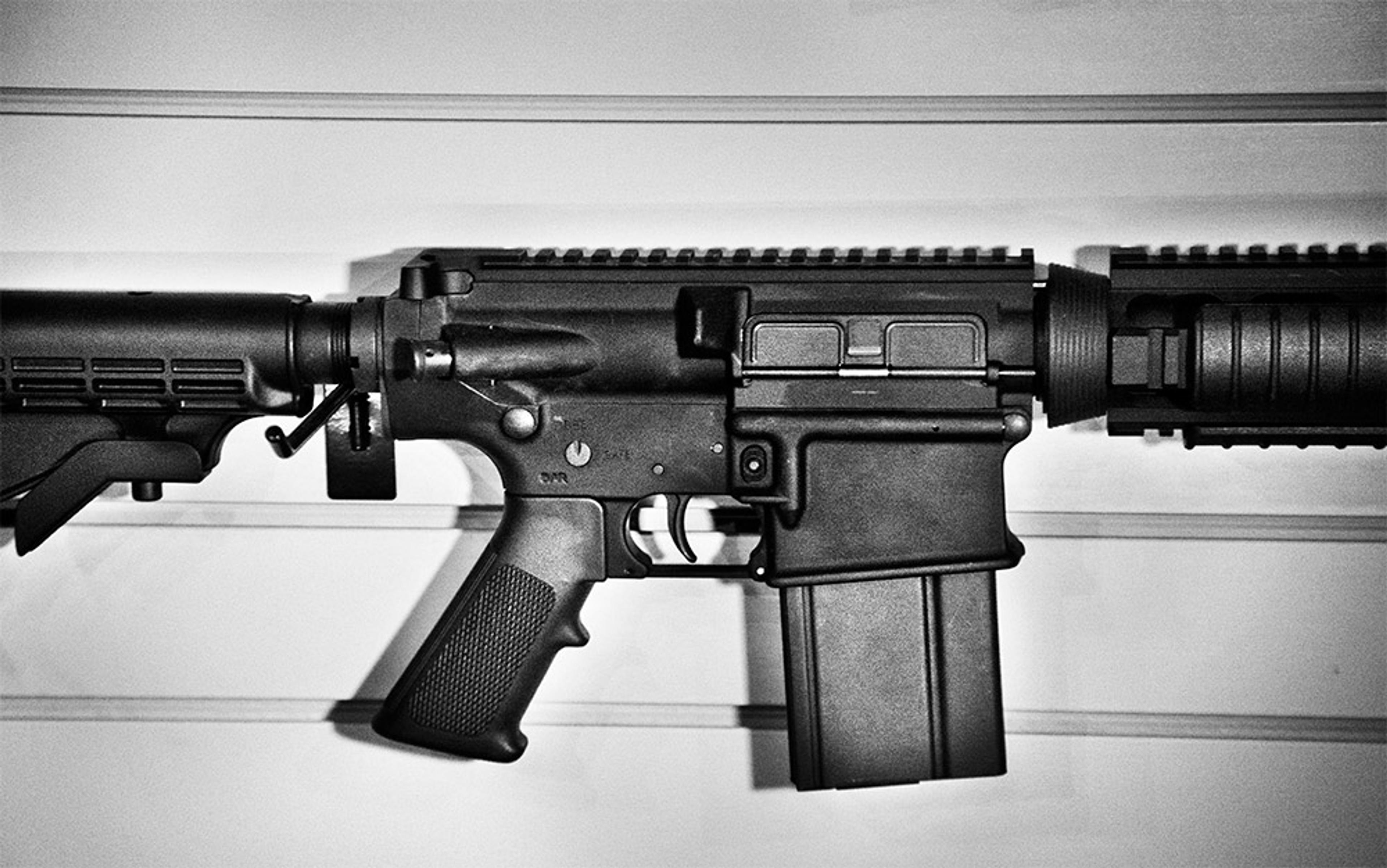 Black-and-white photo of an assault rifle showing the trigger guard, magazine, grip and stock against a plain background.