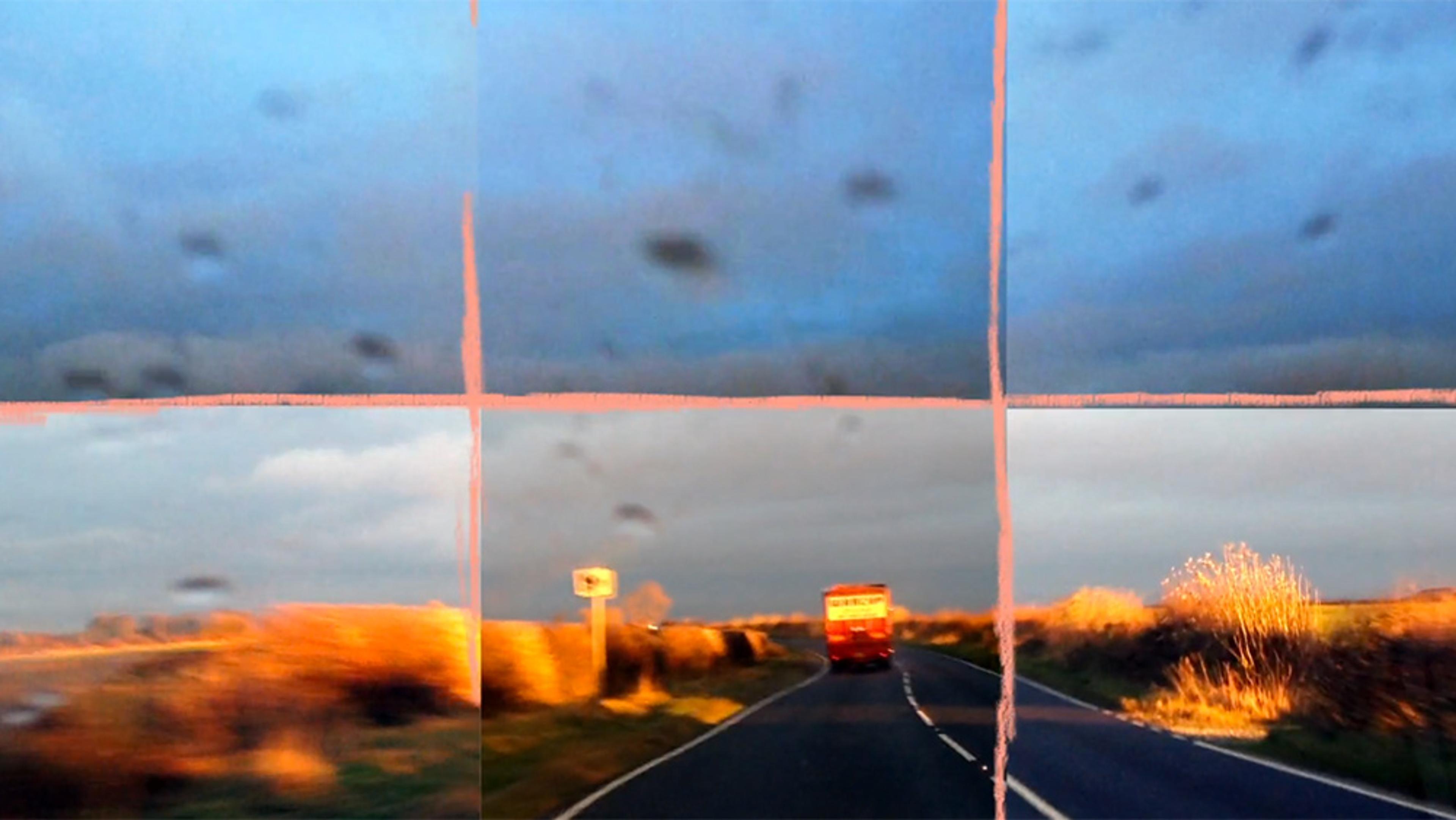 A countryside road with a red vehicle ahead, divided into six sections with some blurry streaks and dark spots on the lens.